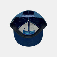 Load image into Gallery viewer, Inside view navy snapback hat with hidden pocket in cap. "A Seattle Legend Since 1954" in light blue on pocket