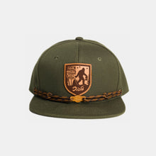 Load image into Gallery viewer, Olive snapback hat w/ tan/brown leather patch w/ Sasquatch carrying DDIR bag. Tan laces & wooden "Dick's" cloud logo clip