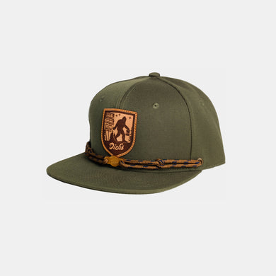 Olive snapback hat w/ tan/brown leather patch w/ Sasquatch carrying DDIR bag. Tan laces & wooden 