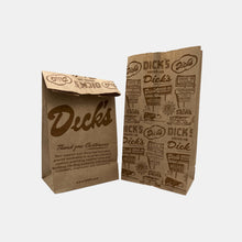 Load image into Gallery viewer, Brown paper bag with Dick&#39;s script logo &amp; thank you on 1 side and repeating steer, sign, and logos pattern on other side
