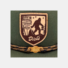 Load image into Gallery viewer, Detail of tan &amp; brown leather patch w/ Sasquatch carrying DDIR bag &amp; pylon sign. Tan laces &amp; wooden &quot;Dick&#39;s&quot; cloud logo clip
